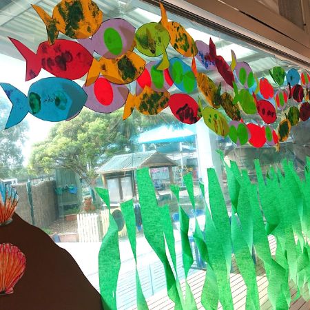 Inside the centre: fish and seaweed craft displayed on the window