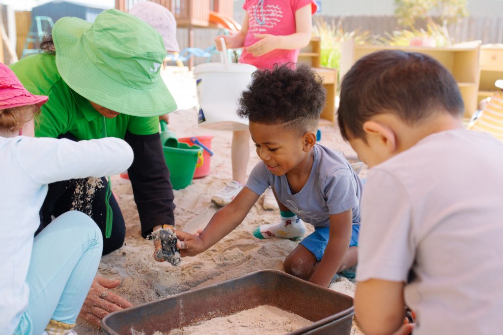 alt=Three-Year-Old Kinder children playing in sandpit