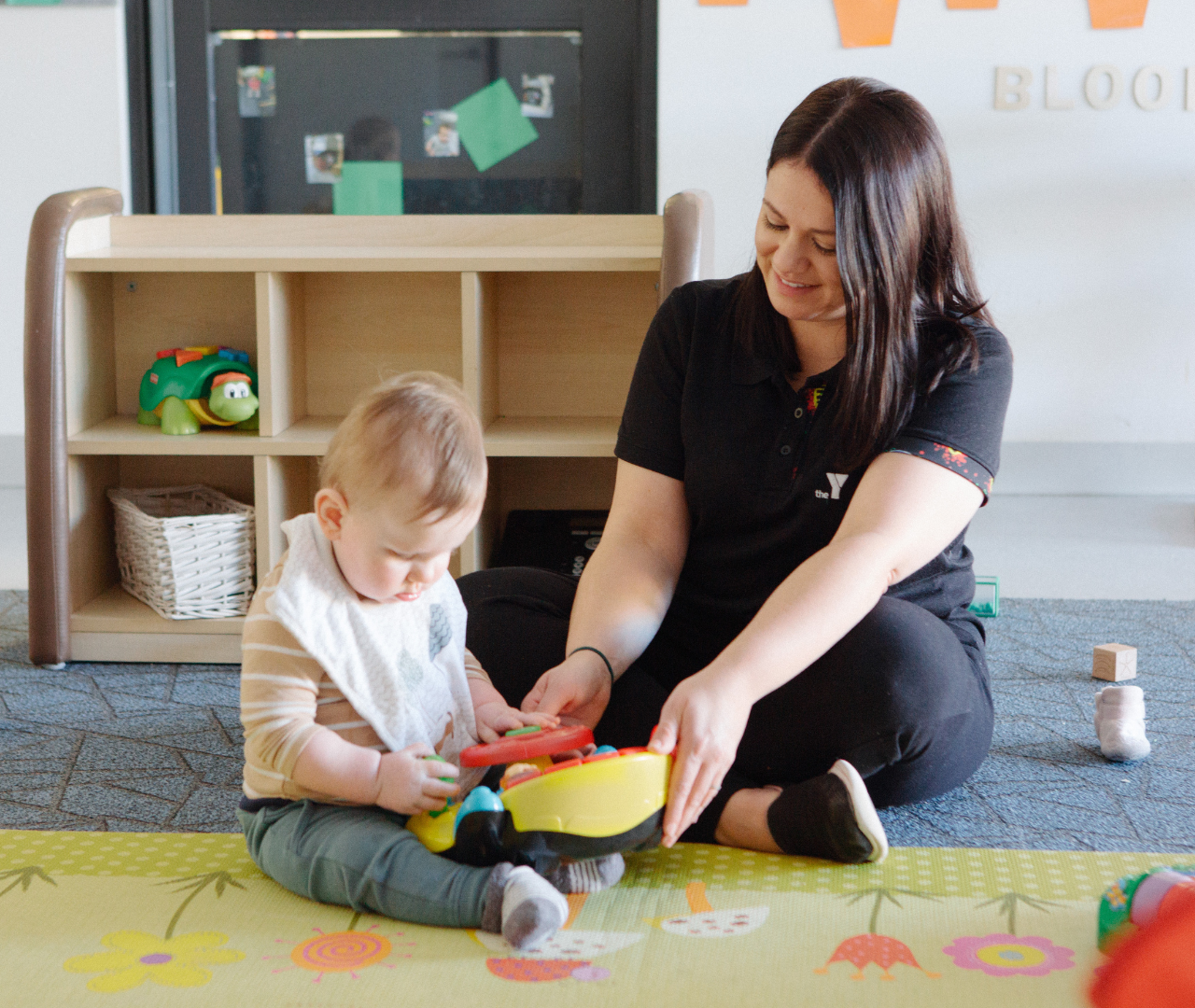 Educator and baby playing with toys